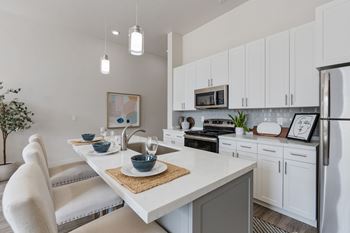 Kitchen with island and white chairs